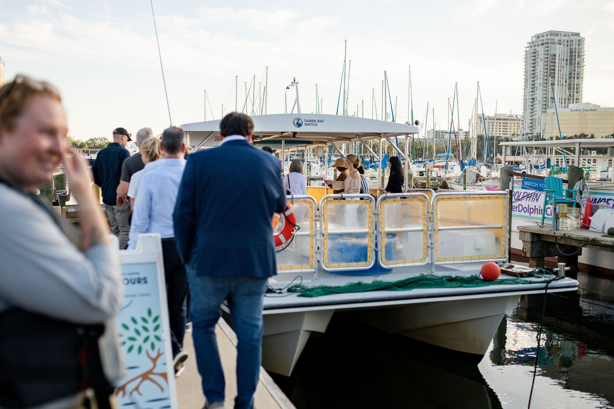 A group of people boarding a boat.