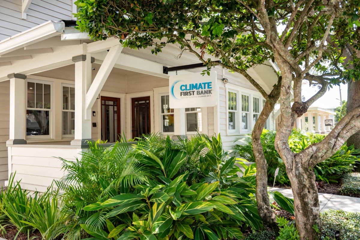 Front porch of the Downtown Orlando branch with a Climate First Bank sign and tropical landscaping