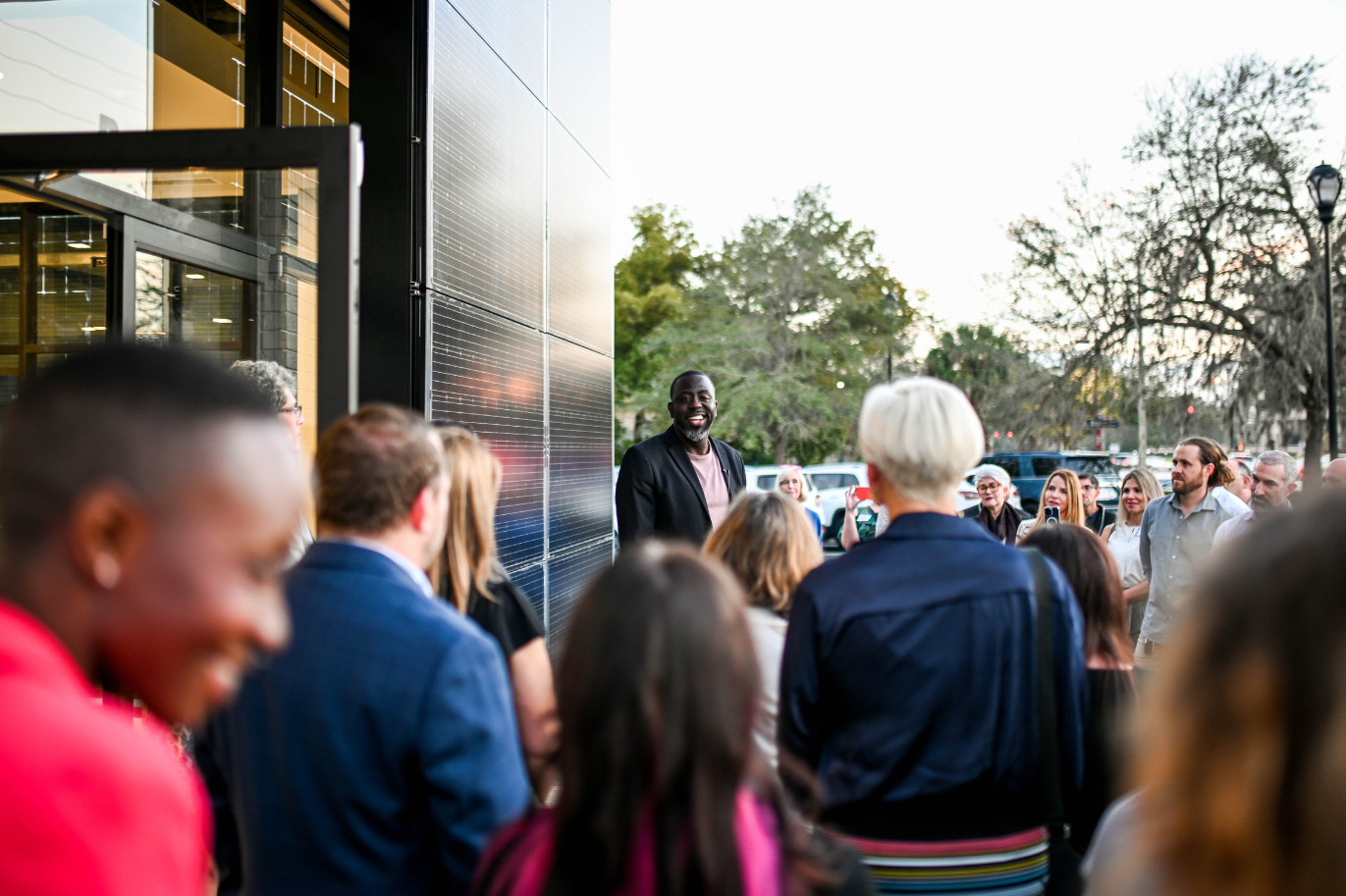 Group of people gathered around a Climate First Bank branch location.