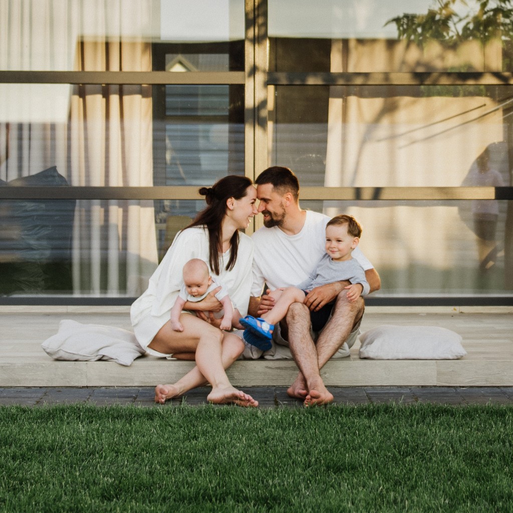 Family sitting together on the porch of their home